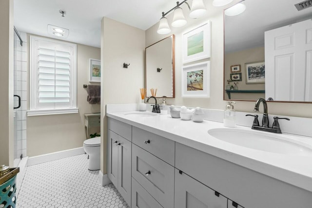 bathroom with visible vents, a shower stall, toilet, and a sink