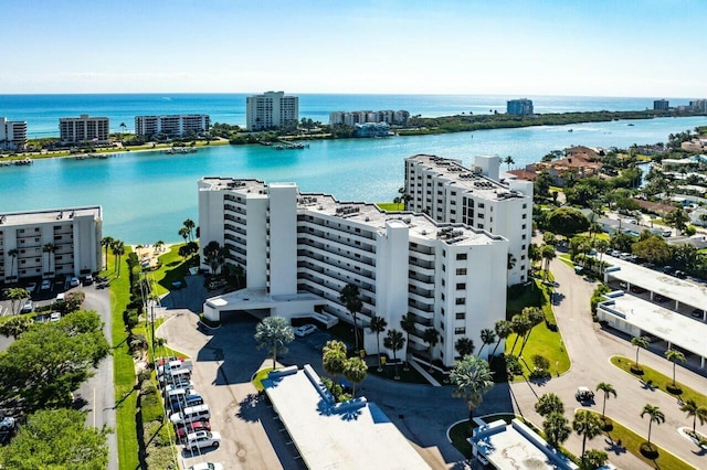 birds eye view of property featuring a city view and a water view