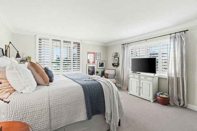 bedroom featuring light carpet, baseboards, ornamental molding, and multiple windows