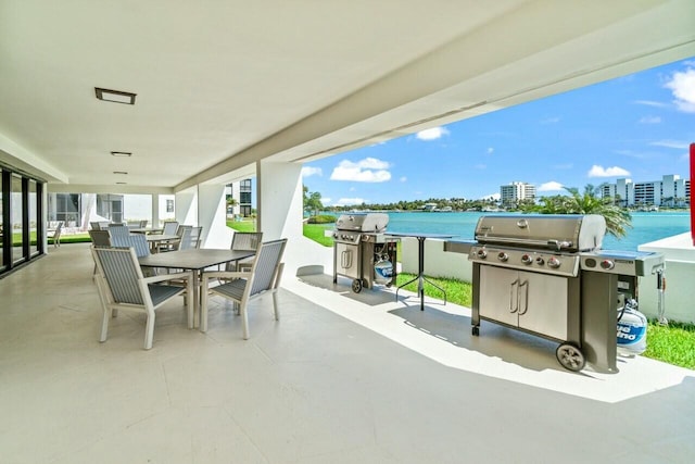 view of patio / terrace with outdoor dining area, a view of city, and grilling area