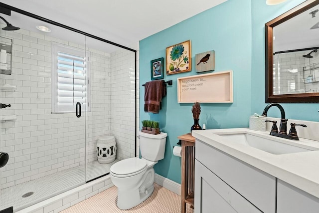 full bath with a shower stall, tile patterned flooring, toilet, vanity, and baseboards