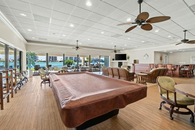 game room featuring a paneled ceiling, light wood-style flooring, a ceiling fan, crown molding, and pool table