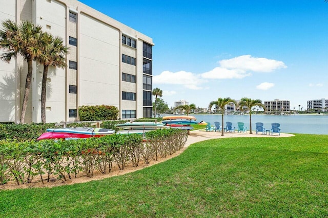 view of community featuring a water view and a lawn