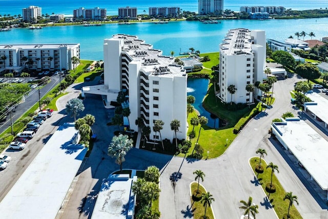 drone / aerial view featuring a city view and a water view