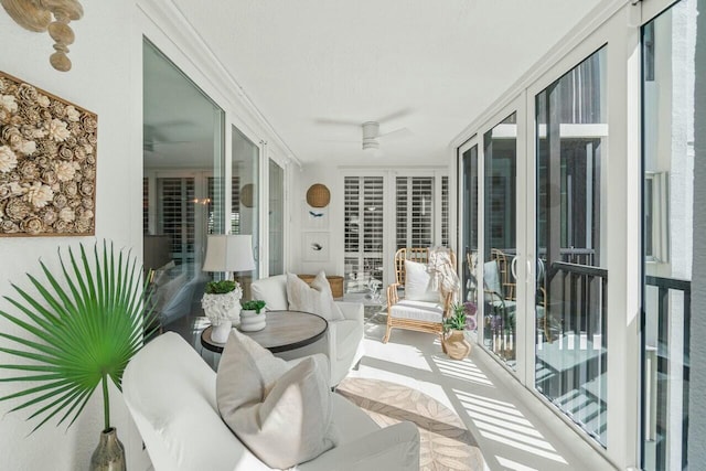 sunroom / solarium featuring plenty of natural light and ceiling fan
