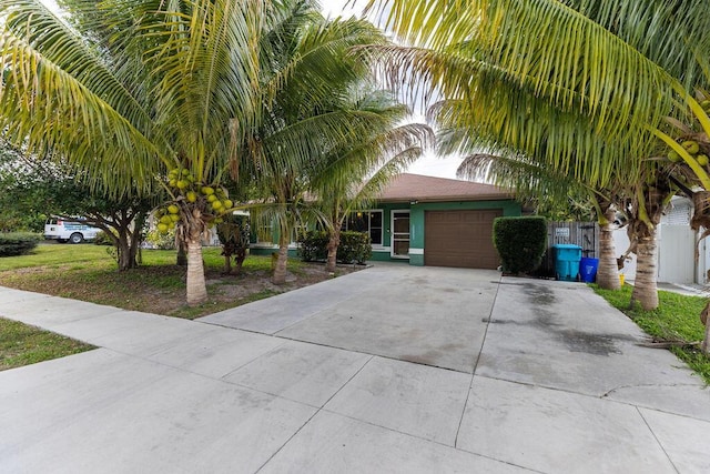 obstructed view of property with a garage and driveway