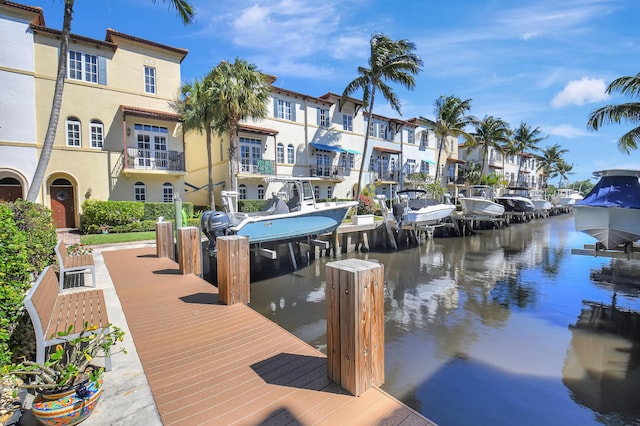 view of dock with a water view and a residential view