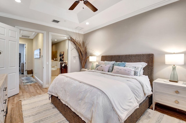 bedroom with recessed lighting, visible vents, baseboards, light wood finished floors, and a raised ceiling