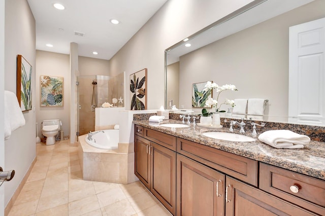 bathroom with a garden tub, a sink, toilet, and a shower stall