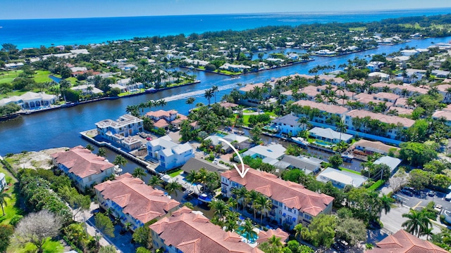 drone / aerial view with a residential view and a water view