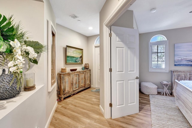 bathroom featuring wood finished floors, visible vents, and baseboards