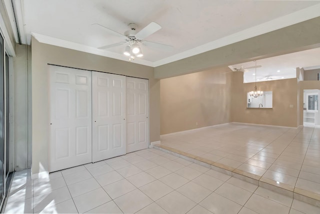 unfurnished bedroom featuring light tile patterned flooring, baseboards, a closet, and ornamental molding