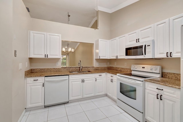 kitchen with ornamental molding, white appliances, white cabinets, and a sink