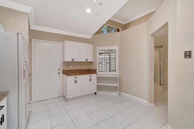 kitchen with light tile patterned floors, light stone countertops, ornamental molding, white cabinets, and white fridge with ice dispenser