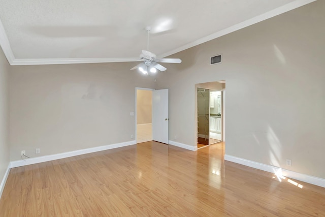 spare room featuring a ceiling fan, baseboards, visible vents, ornamental molding, and light wood-type flooring