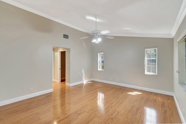 unfurnished room featuring visible vents, lofted ceiling, baseboards, and light wood-style flooring