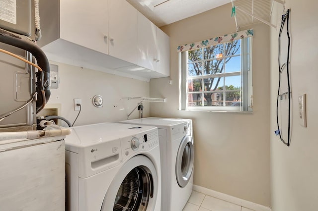 laundry area with cabinet space, light tile patterned floors, independent washer and dryer, and baseboards