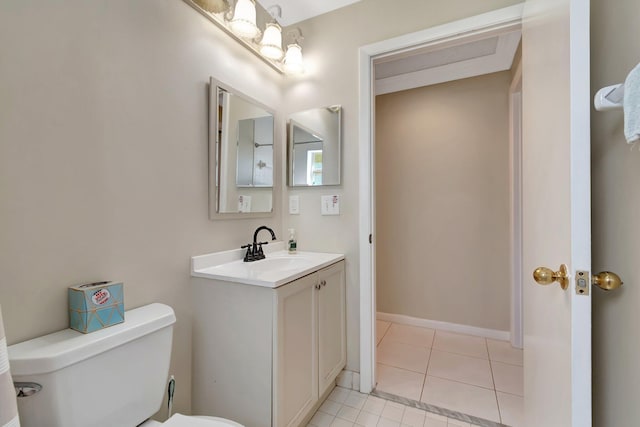 half bath featuring tile patterned floors, toilet, vanity, and baseboards