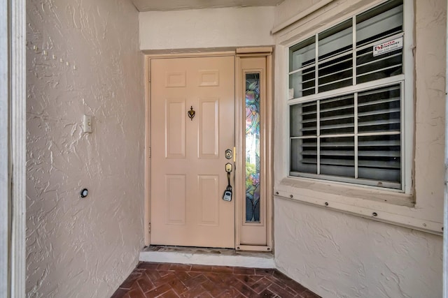 view of exterior entry featuring stucco siding