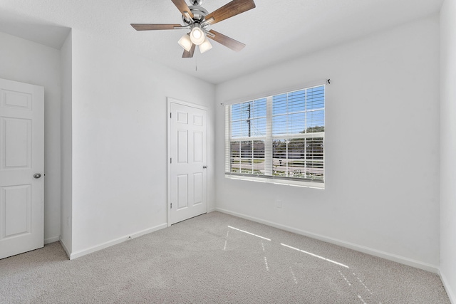 unfurnished bedroom featuring ceiling fan, baseboards, and carpet