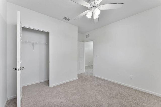 unfurnished bedroom with carpet, visible vents, a closet, and baseboards