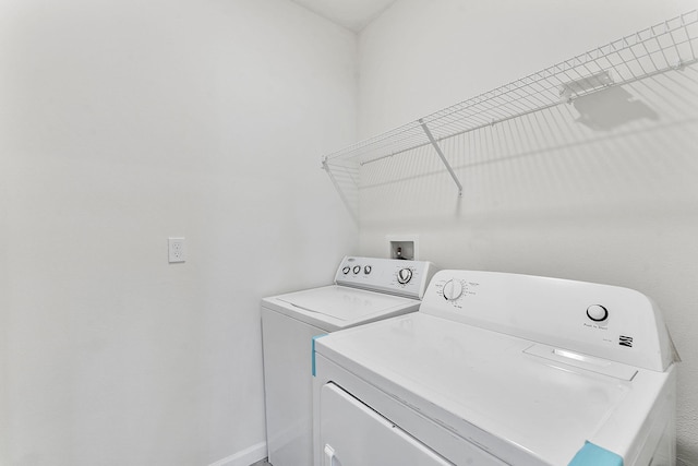 laundry room with baseboards, washing machine and dryer, and laundry area