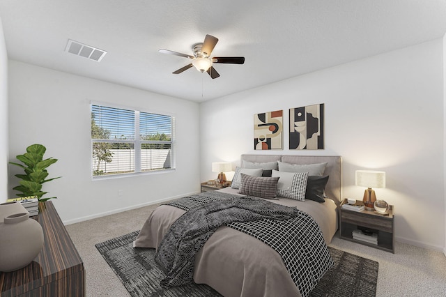 bedroom featuring visible vents, carpet floors, baseboards, and a ceiling fan