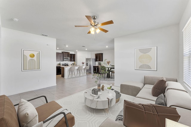 living area featuring light tile patterned floors, visible vents, recessed lighting, and a ceiling fan