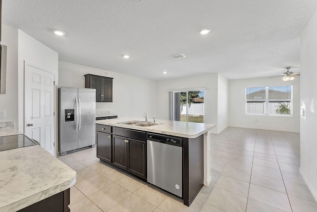 kitchen with a sink, stainless steel appliances, plenty of natural light, and light countertops