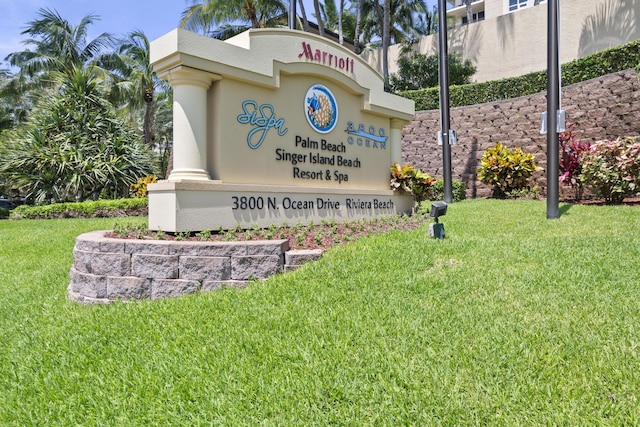 community / neighborhood sign with a lawn