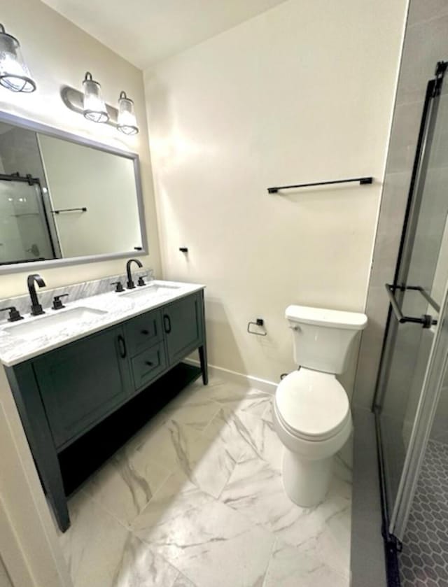 full bathroom featuring a stall shower, marble finish floor, and a sink