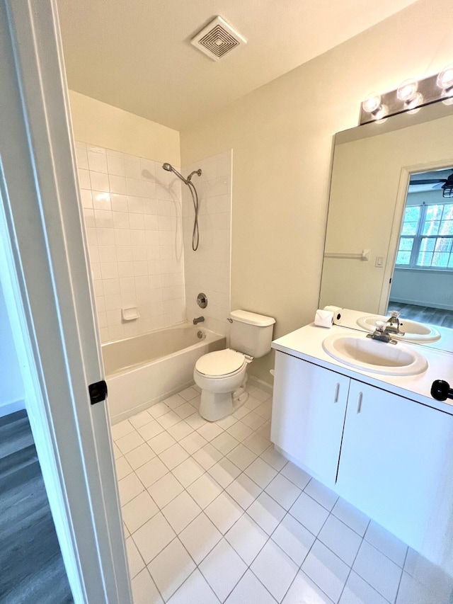 full bathroom featuring visible vents, toilet, vanity,  shower combination, and tile patterned floors