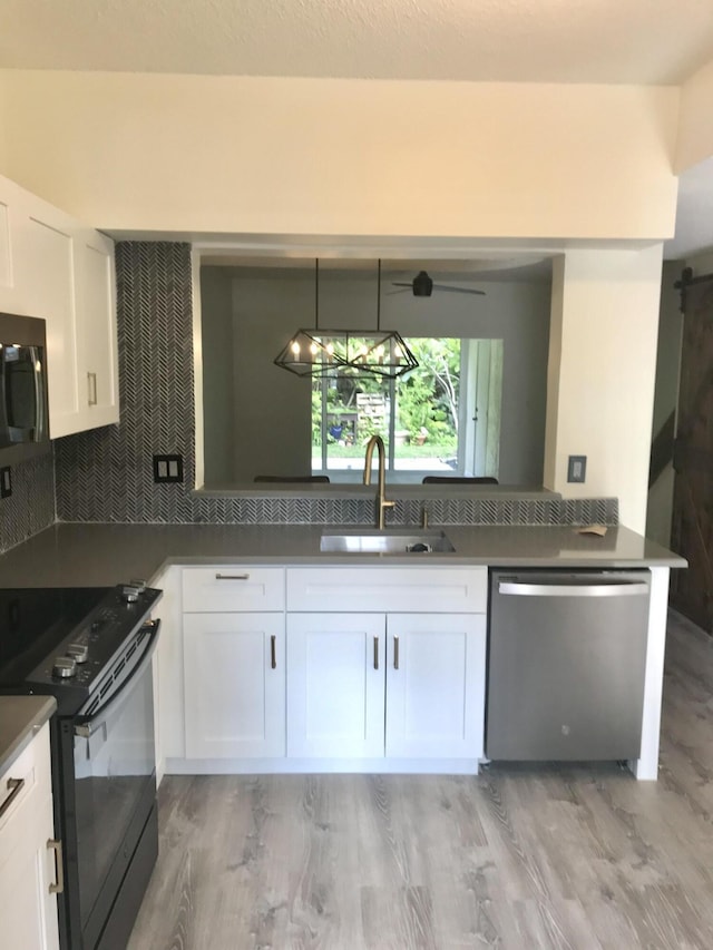 kitchen with dishwasher, a sink, white cabinets, and black electric range oven