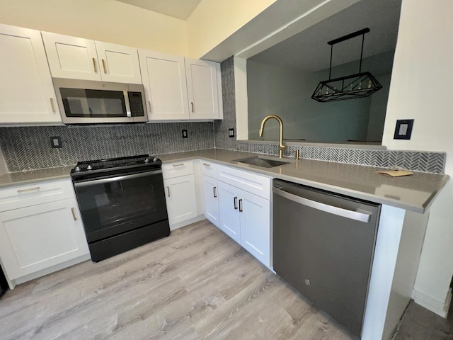 kitchen with white cabinets, tasteful backsplash, stainless steel appliances, and a sink