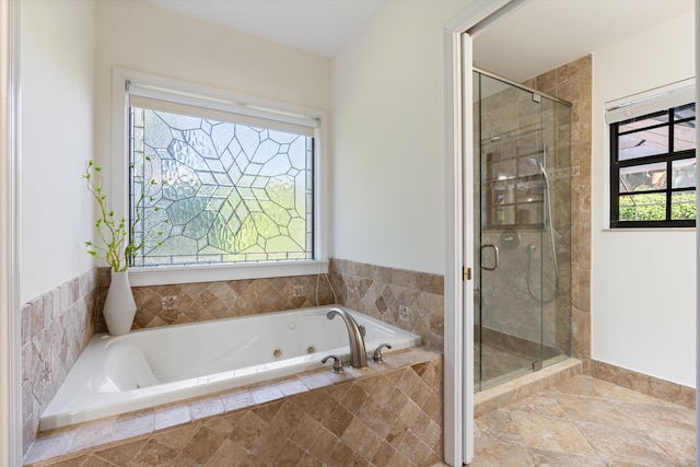 full bathroom featuring a shower stall and a jetted tub