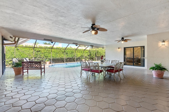 view of patio / terrace featuring ceiling fan, outdoor dining area, an outdoor pool, and a lanai