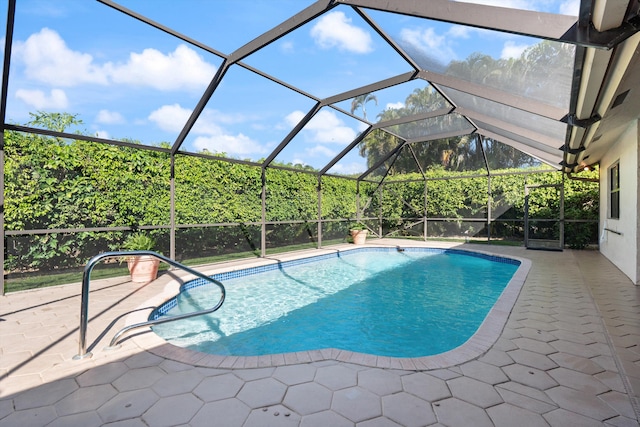 pool featuring a patio area and glass enclosure