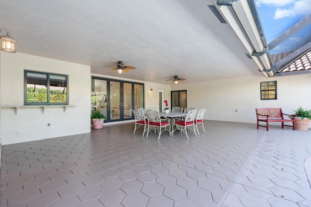 view of patio with outdoor dining space and a ceiling fan