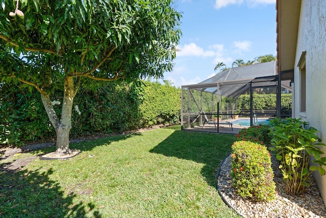 view of yard with a lanai and an outdoor pool
