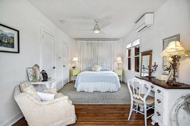 bedroom featuring ceiling fan, baseboards, wood finished floors, and a wall mounted AC