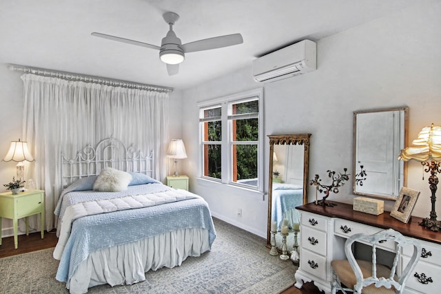 bedroom with a wall mounted AC, wood finished floors, a ceiling fan, and baseboards