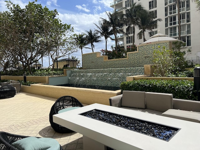 view of patio / terrace featuring an outdoor fire pit and fence