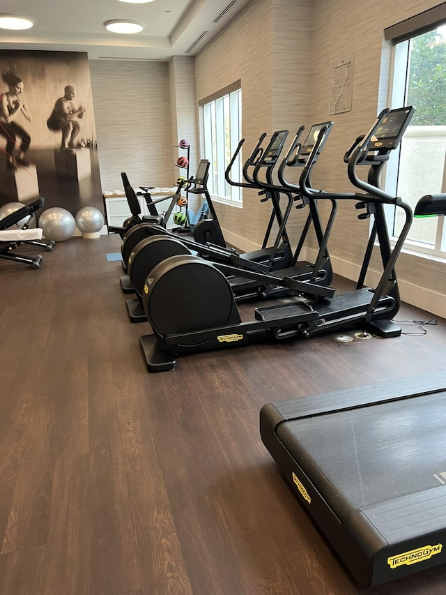 workout area featuring baseboards and wood finished floors