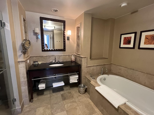 bathroom featuring vanity and a bath