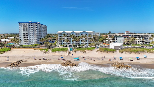 birds eye view of property featuring a water view, a city view, and a view of the beach