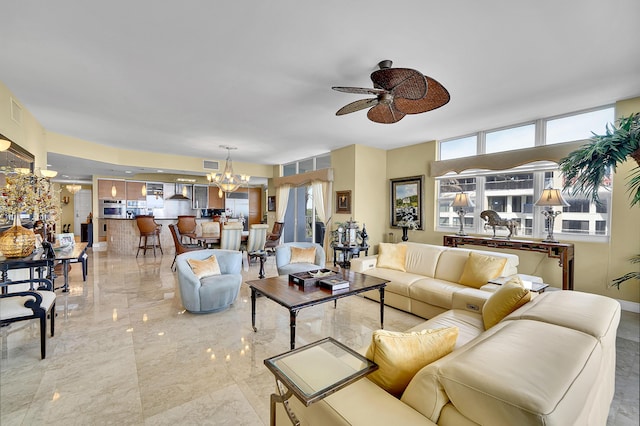 living room featuring marble finish floor, visible vents, and ceiling fan with notable chandelier