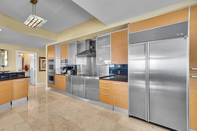 kitchen featuring stainless steel appliances, wall chimney range hood, dark countertops, and modern cabinets