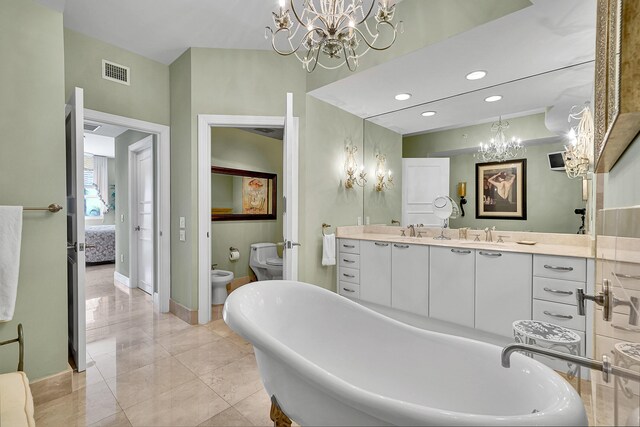 bathroom with double vanity, visible vents, a freestanding bath, a bidet, and a sink