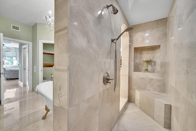 bathroom with marble finish floor, visible vents, a tile shower, and a freestanding bath