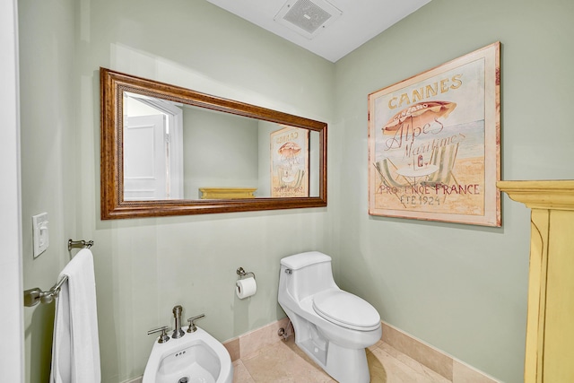 bathroom featuring a bidet, tile patterned flooring, visible vents, and baseboards